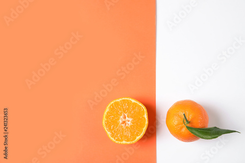 Flat lay composition with ripe tangerines on color background. Space for text