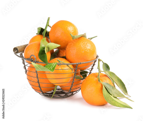 Metal basket with tasty ripe tangerines on white background