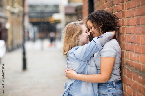 Lesbian couple kissing in the street