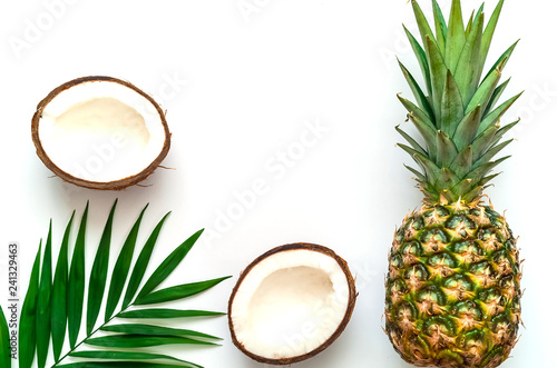 Tropical background with pineapple and coconut on isolated white background.