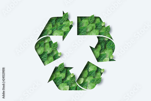 Recycling icon made from green leaves. Light background. The concept of recycling, non-waste production, eco-plastic, eco fuel.