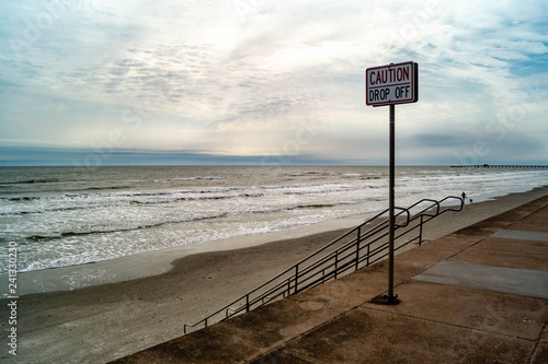 Warning sign at the Seawall in Galveston, Texas on the Gulf of Mexico