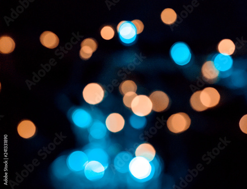 image of blurred bokeh background with colorful lights, vintage tone © mdyn