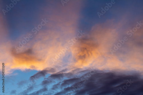 Clouds during sunset. The sky is dyed golden colors.