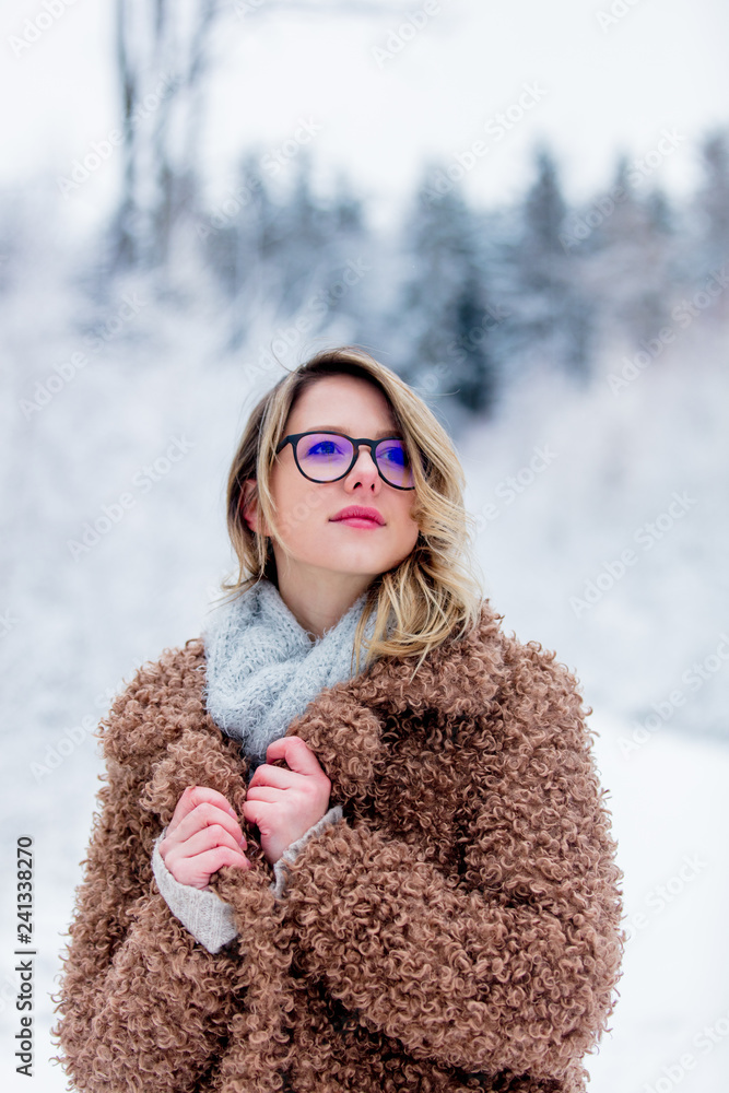 Beautiful girl in coat in a snow forest. Christmas of Valentine Day season time Beautiful girl in coat in a snow forest. Christmas of Valentine Day season time