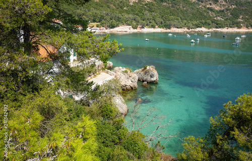 coastline at Portinho da Arrabida bay with moored boats, Setubal, Portugal photo