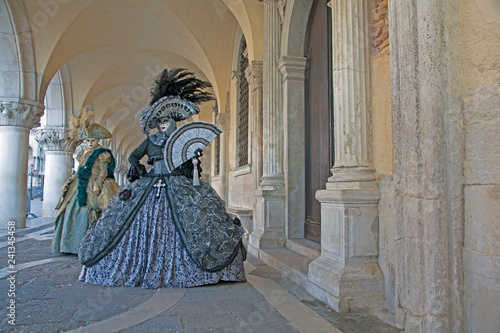 Bilde på lerret Venice Carnival masks and  costumes under the arcade of the Doges Palace St