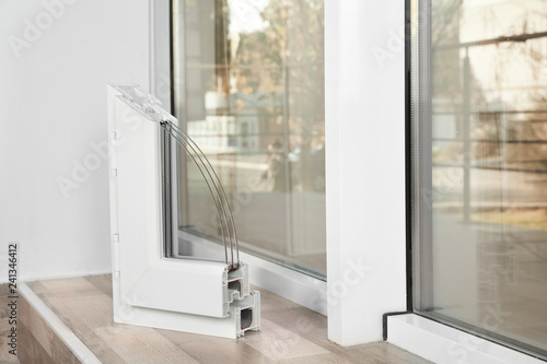 Sample of modern window profile on sill indoors, space for text. Installation service