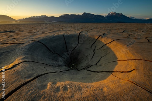 Cracky, dried out soil and Allgau Alps in the background at sunrise, Forggensee, Fussen, Ostallgau, Bavaria, Germany, Europe