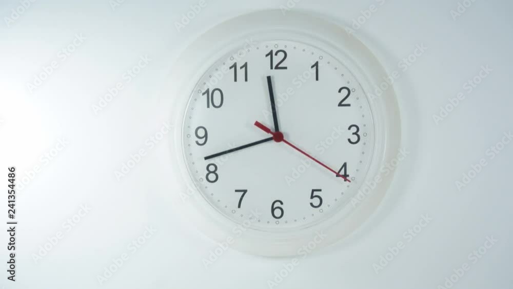 Close-up White clock with Black numbers and arrows on White background, Time Lapse Clock walking 20 minute. Close-up White clock with Black numbers and arrows on White background, Time Lapse Clock walking 20 minute.