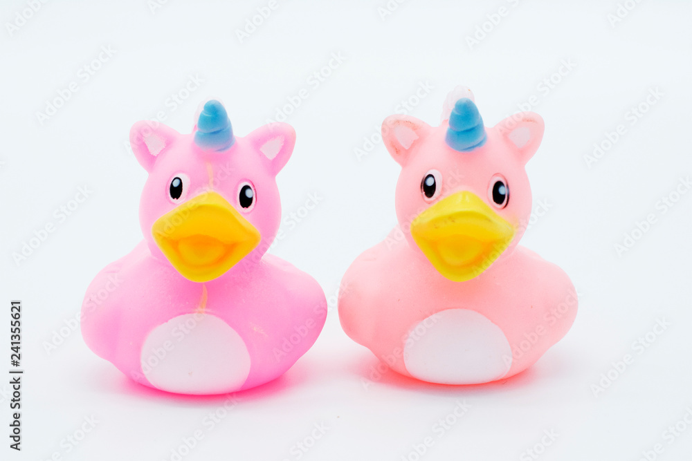 Two pink unicorn rubber ducks on an isolated white background Two pink unicorn rubber ducks on an isolated white background