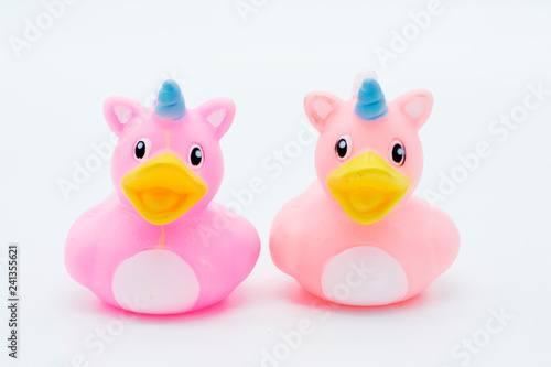 Two pink unicorn rubber ducks on an isolated white background