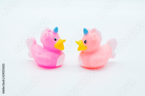 Two pink unicorn rubber ducks on an isolated white background