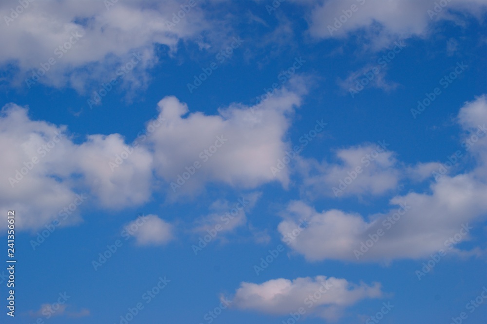 White cumulus clouds blue sky