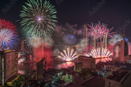 Fantastic Multicolor Firework exploding over the Bangkok Cityscape river side for Celebration, Business architecture and celebration and happy new year and merry christmas concept © THANANIT