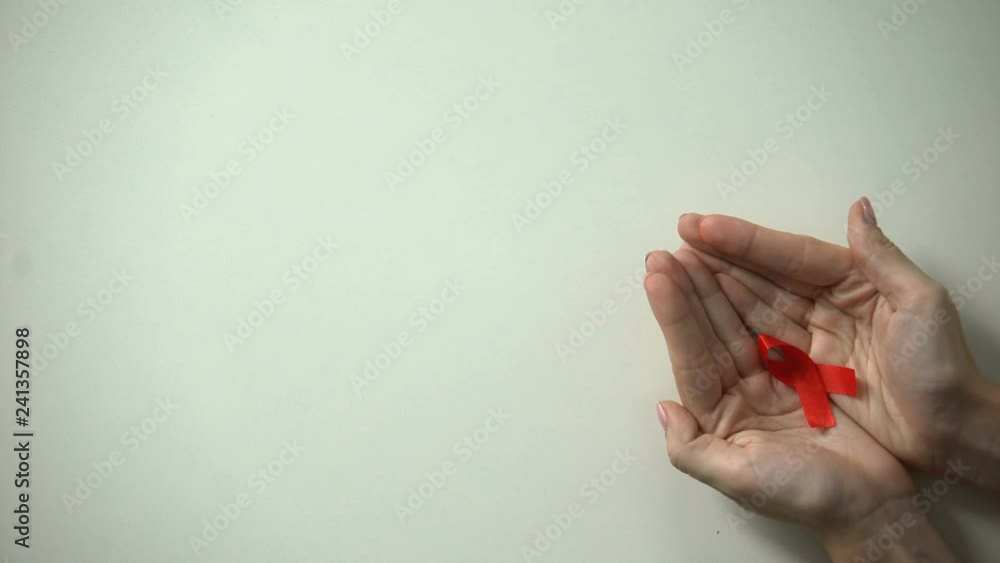 Red ribbon in female hands, world AIDS and HIV day, awareness campaign ...
