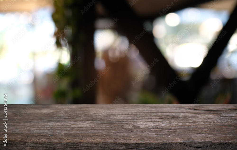 Empty dark wooden table in front of abstract blurred bokeh background of restaurant . can be used for display or montage your products.Mock up for space. Empty dark wooden table in front of abstract blurred bokeh background of restaurant . can be used for display or montage your products.Mock up for space.