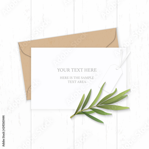 Flat lay top view elegant white composition letter kraft paper envelope tarragon leaf and taag on wooden background photo