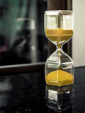 Modern hexagon hourglass with golden sand seed