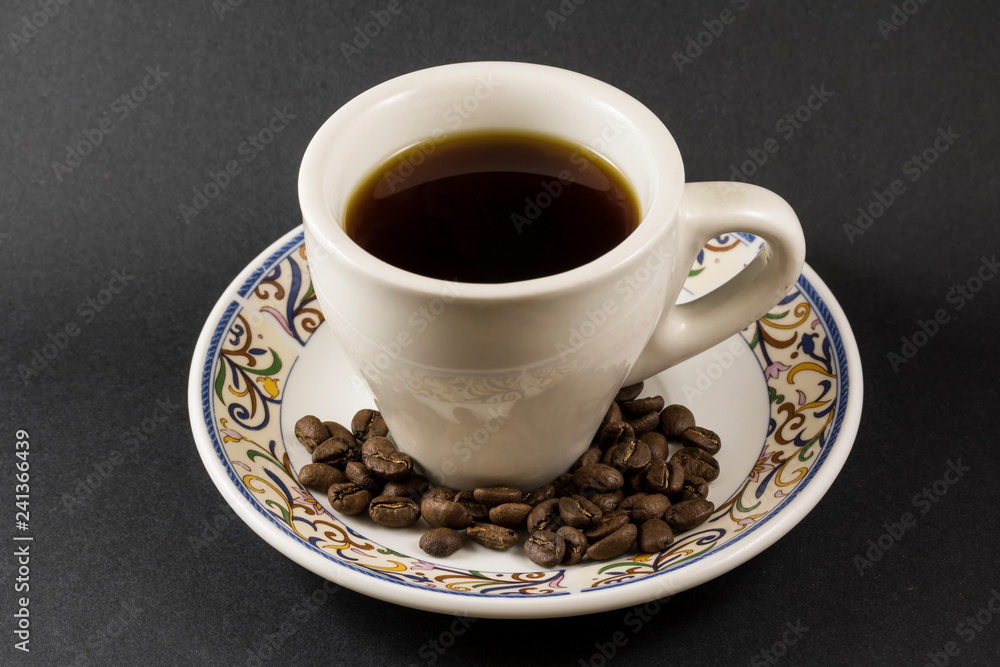 A cup of Antigua Coffee with some roasted coffe beans (pacamara) A cup of Antigua Coffee with some roasted coffe beans (pacamara)