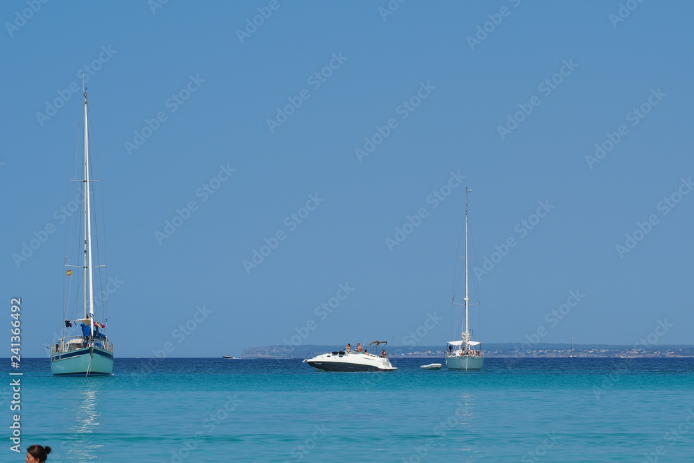 Colonia Sant Jordi, Ses Salines, Spain. Amazing view of the boats with a turquoise sea close to the charming beach of Es Trencs. It has earned the reputation of Caribbean beach of Mallorca