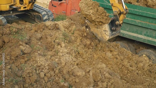 excavator loads a truck