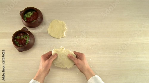 Cooker stirring dough in glass bowl top view photo