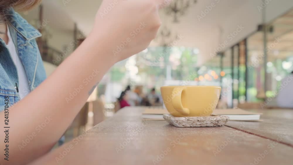 Female blogger photographing green tea cup in cafe with her phone. A young woman taking photo of coffee tea on smartphone, photographing meal with mobile camera. Female blogger photographing green tea cup in cafe with her phone. A young woman taking photo of coffee tea on smartphone, photographing meal with mobile camera.