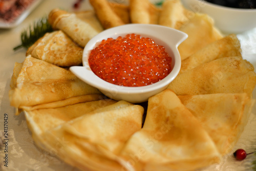 traditional thin Russian pancakes with red caviar