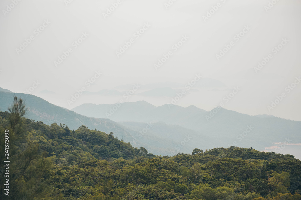 Mountain and ocean view in Lantau Island, Hong Kong. Landscape hill scene with fog. Mountain and ocean view in Lantau Island, Hong Kong. Landscape hill scene with fog.