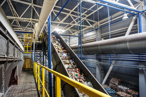 Photos moving conveyor transporter on Modern waste recycling processing plant