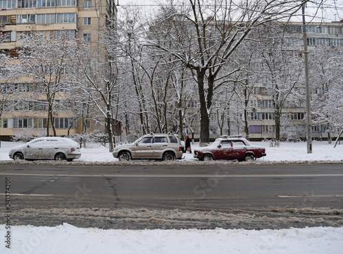 View through the asphalt on three cars in the city in winter. © YAROSLOVEPHOTOVIDEO
