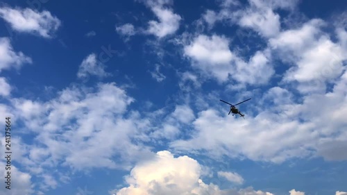 The civil helicopter flying from right to left the bottom view
