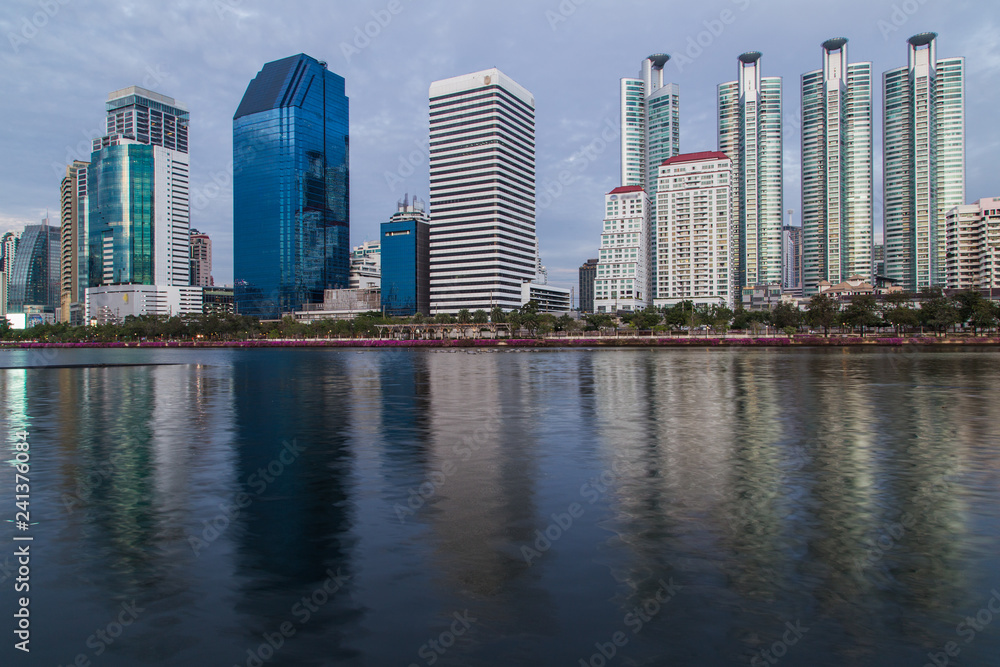 Bangkok twilight, Business building with light and reflection, view from Benjakitti park in Bangkok, Thailand