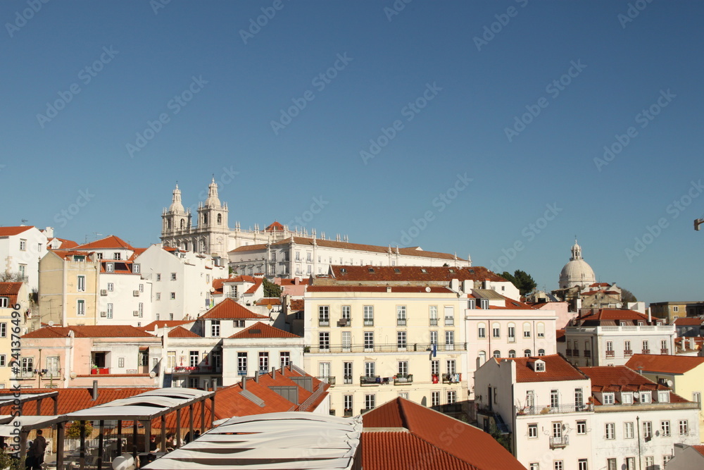 White houses with red rooftops and blue sky