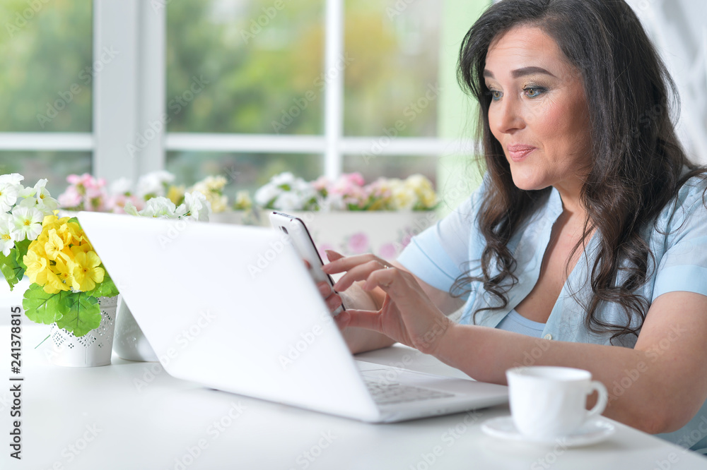 Portrait of beautiful mature woman using laptop Portrait of beautiful mature woman using laptop