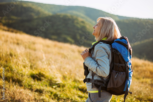 Senior woman is hiking in mountain. Active retirement. 