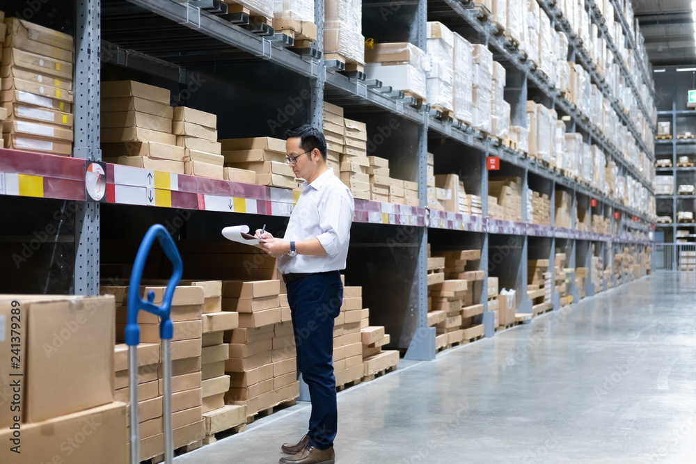 Warehouse worker checking goods at warehouse. Warehouse worker checking goods at warehouse.