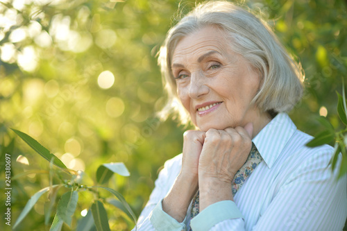 Portrait of happy beautiful elderly woman posing outdoors