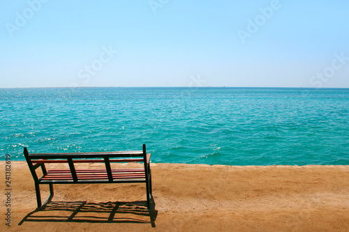 Empty bench near sea. Tropical landscape. Place for relaxation © alexmak