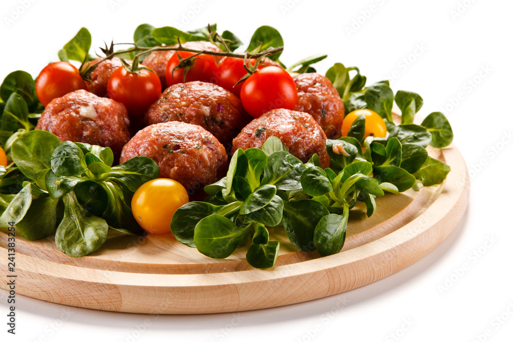 Raw meatballs on cutting board on white background Raw meatballs on cutting board on white background