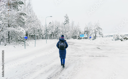 Travel Lifestyle Sweden Young woman backpack walking winter snowy road