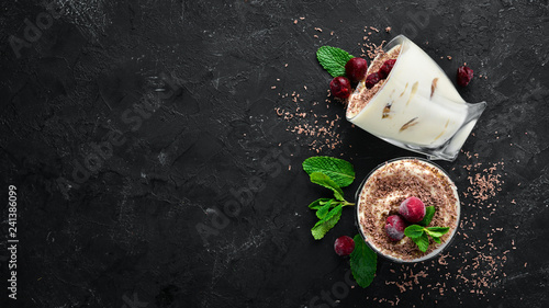Dessert Tiramisu with cherries. Top view. Free space for your text. photo