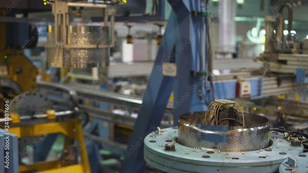 Modern production of household appliances, automatic CNC machine produces aluminum drums for washing machines. Modern production of household appliances, automatic CNC machine produces aluminum drums for washing machines.
