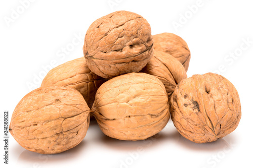 Six whole walnuts, close up macro, isolated on a white background.
