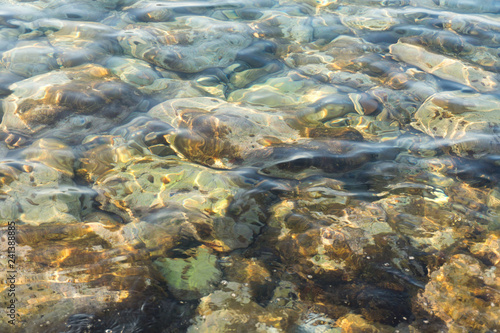Clear water and colorful pebbles on the sea © natagolubnycha