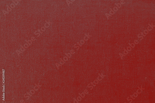 Red cherry background with grid pattern. Canvas texture of old book cover. Toned image