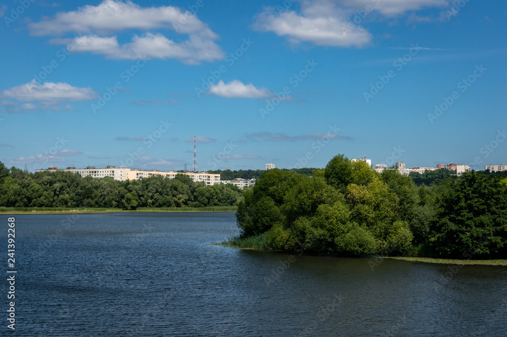 Landscape with a view to high-rise residential buildings located behind the water surface of the Sviyaga River in Ulyanovsk