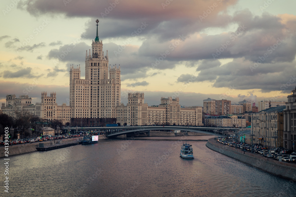 Old soviet skyscraper on Kotelnicheskaya embankment and Moskva river evening view from the bridge