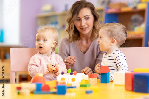 Children with teacher playi...